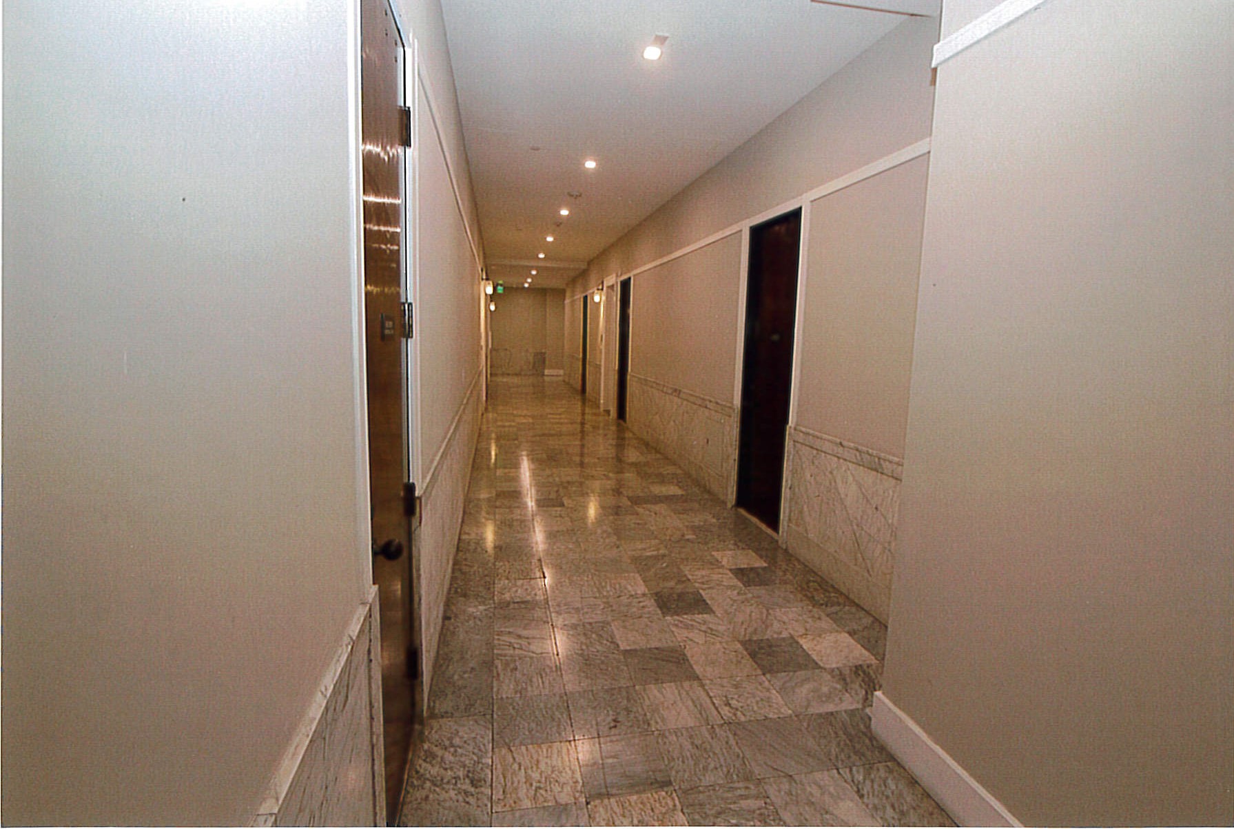 Rehabilitated 3rh floor corridor showing original marble wainscoting and flooring. Removed dropped ceiling. 